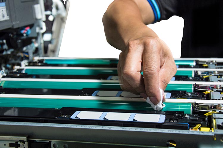 technician hand cleaning color copier drum in overhaul process on  isolate background